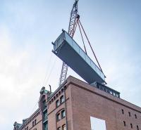 Canal bridge lifted into place over Hamburg warehouses image